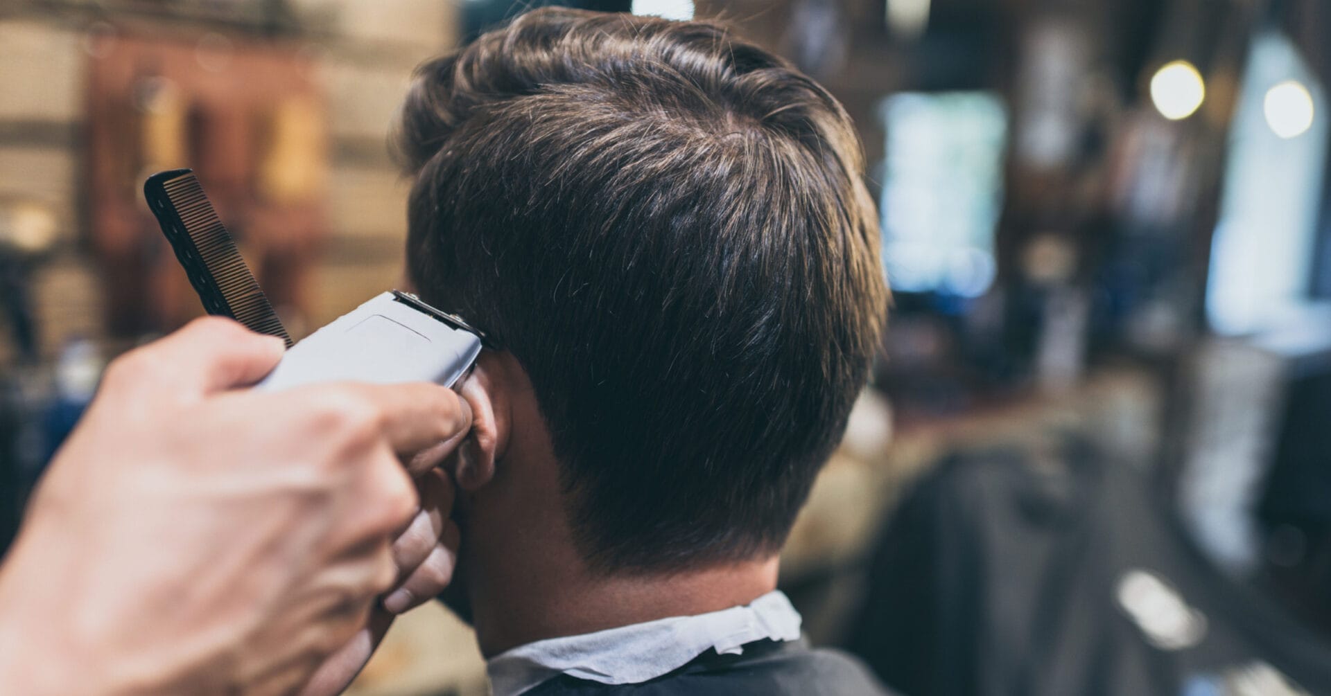 close up of a stylish haircut with clippers in an iligan barbershop, focusing on the back of the head.